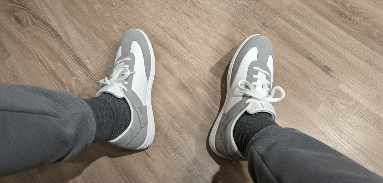 GRAYAMZ prototype shoes on feet on a wooden floor